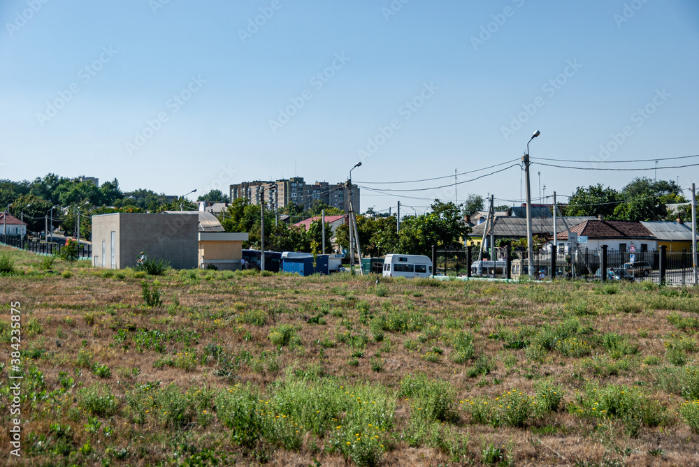 Obraz na płótnie Tiraspol, Transdniester, 1 September 2017. Grass field and homes in a residential area on the outskirts of Tiraspol. w salonie