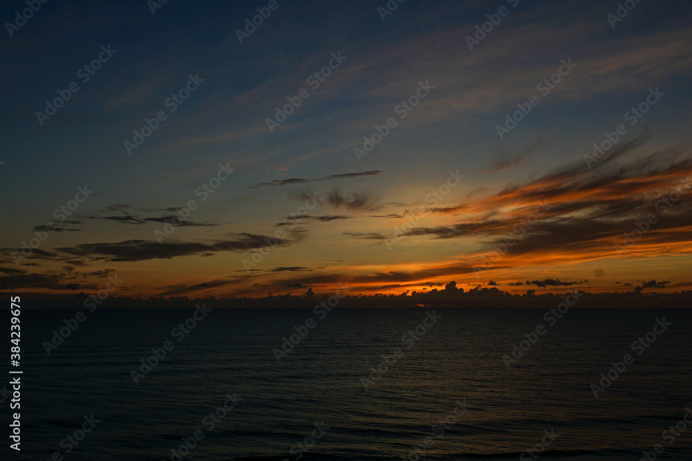 A blue, yellow, and orange sunrise over the Atlantic Ocean