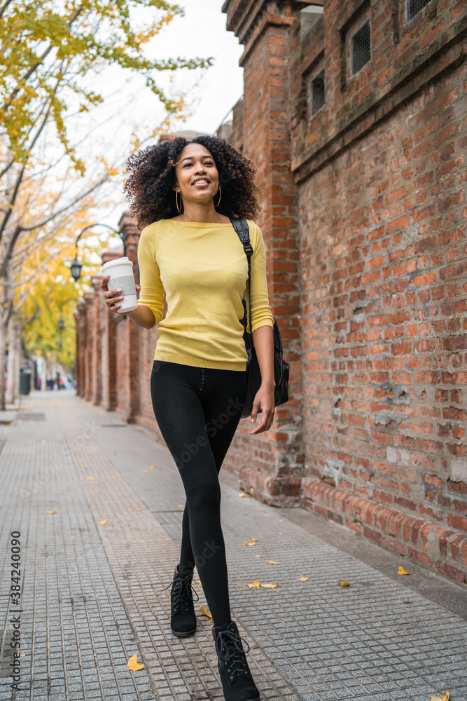 Afro-american woman walking on the street.