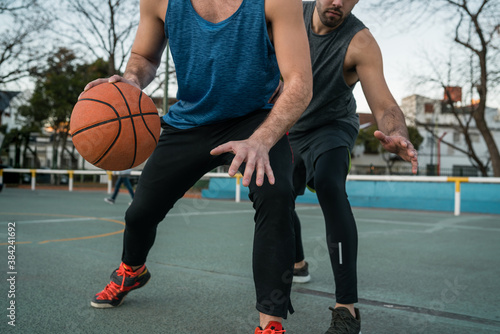 Young basketball players playing one-on-one.