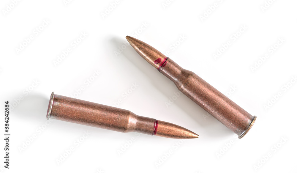 Fototapeta premium Two copper machine gun bullets isolated on white background