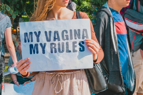 Obraz na płótnie The phrase  My vagina my rules  on a banner in women's hand