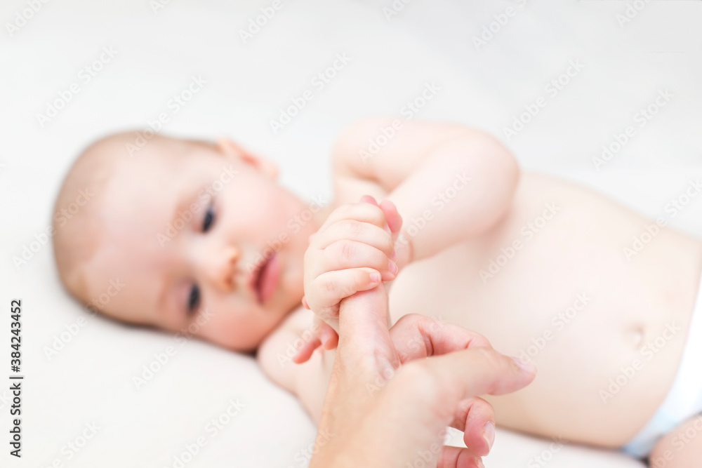Baby girl holding mothers finger Baby girl holding mothers finger