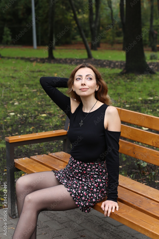 Woman sitting on the bench in the park Woman sitting on the bench in the park