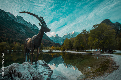 Capricorn statue at the Lake Jasna in kranjska gora in early autumn. © Anze