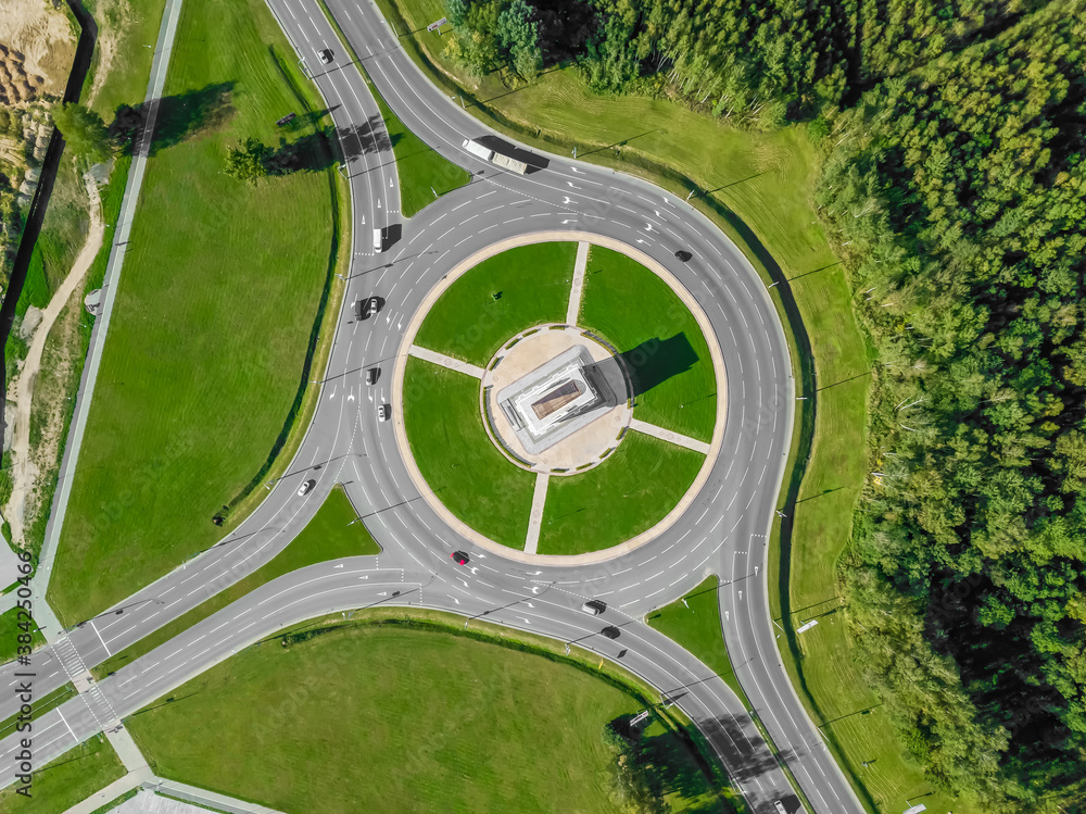Aerial view of the ring road with a three-way fork on a Sunny summer day. City infrastructure. Beautiful top view of the ring road. Different path direction Aerial view of the ring road with a three-way fork on a Sunny summer day. City infrastructure. Beautiful top view of the ring road. Different path direction