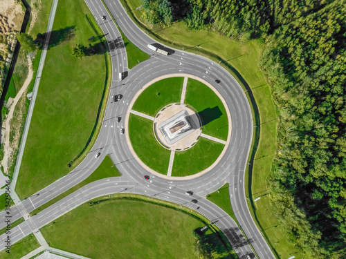 Aerial view of the ring road with a three-way fork on a Sunny summer day. City infrastructure. Beautiful top view of the ring road. Different path direction © yaroslav1986