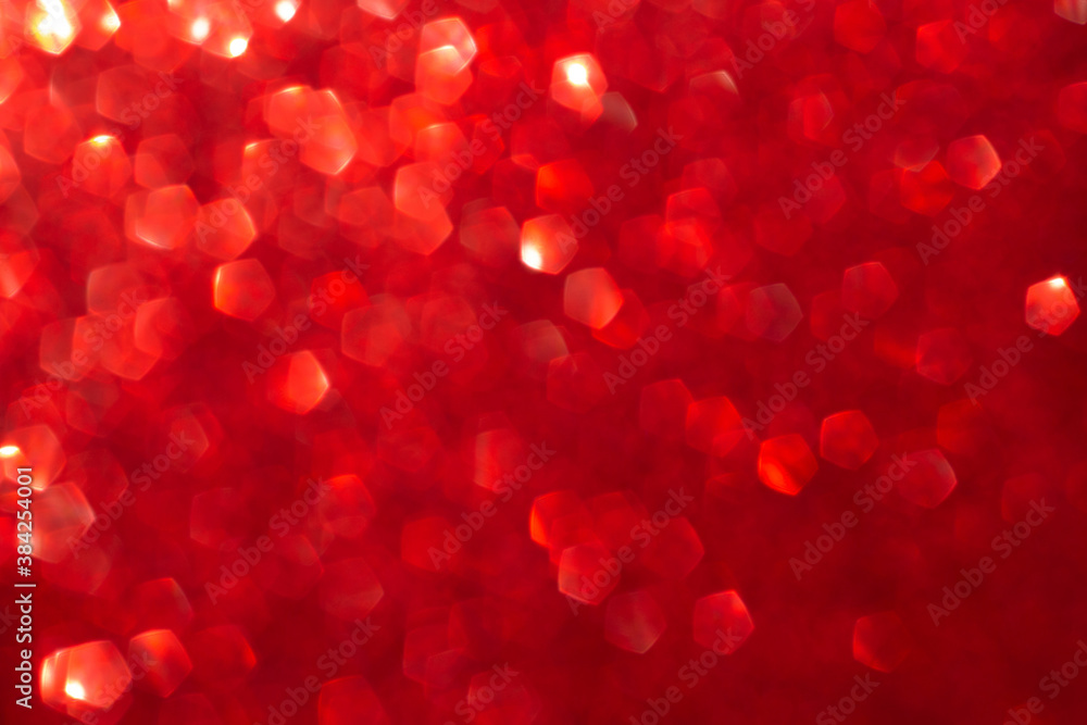 Red shiny blurred background with bokeh lights. Abstract festive background. Christmas, Valentine day concept.