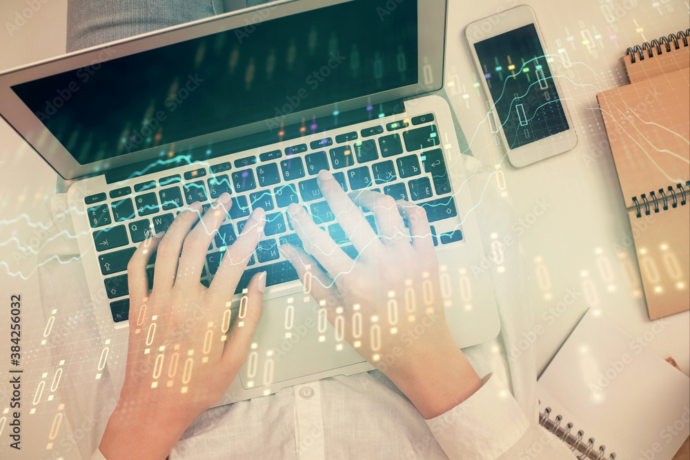 Double exposure of woman hands working on computer and forex chart hologram drawing. Top View. Financial analysis concept. Double exposure of woman hands working on computer and forex chart hologram drawing. Top View. Financial analysis concept.