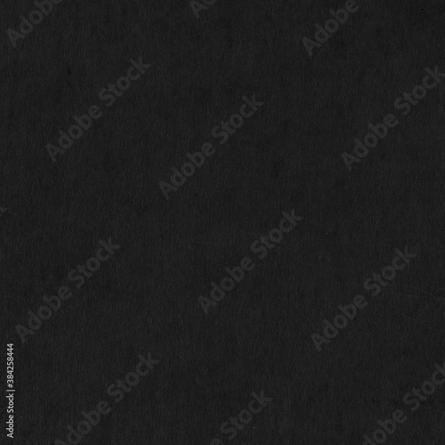 A black vintage rough sheet of carton. Recycled environmentally friendly cardboard paper texture. Simple gray minimalist papercraft background.