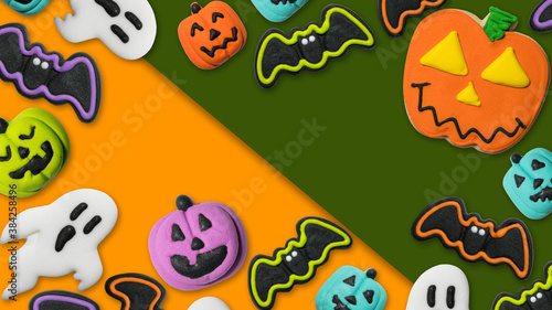Halloween concept pumpkin Jack-o-lantern, bat, ghost. Fun dessert cookie and candy. Trick or treat Happy Halloween. Flat lay, top view. Copy space. Photo good for greeting card, billboard, poster. 