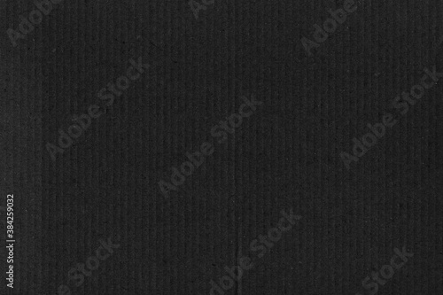 A black vintage rough sheet of carton. Recycled environmentally friendly cardboard paper texture. Simple gray minimalist papercraft background.