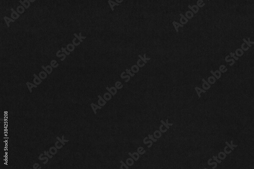 A black vintage rough sheet of carton. Recycled environmentally friendly cardboard paper texture. Simple gray minimalist papercraft background.