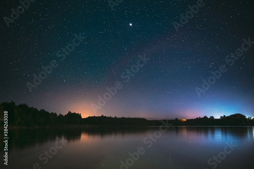 Village Novoye Lyadno, Lyepyel District, Vitebsk Province, Belarus. Real Colorful Night Stars Above Lepel Lake. Natural Starry Sky Background Backdrop Landscape