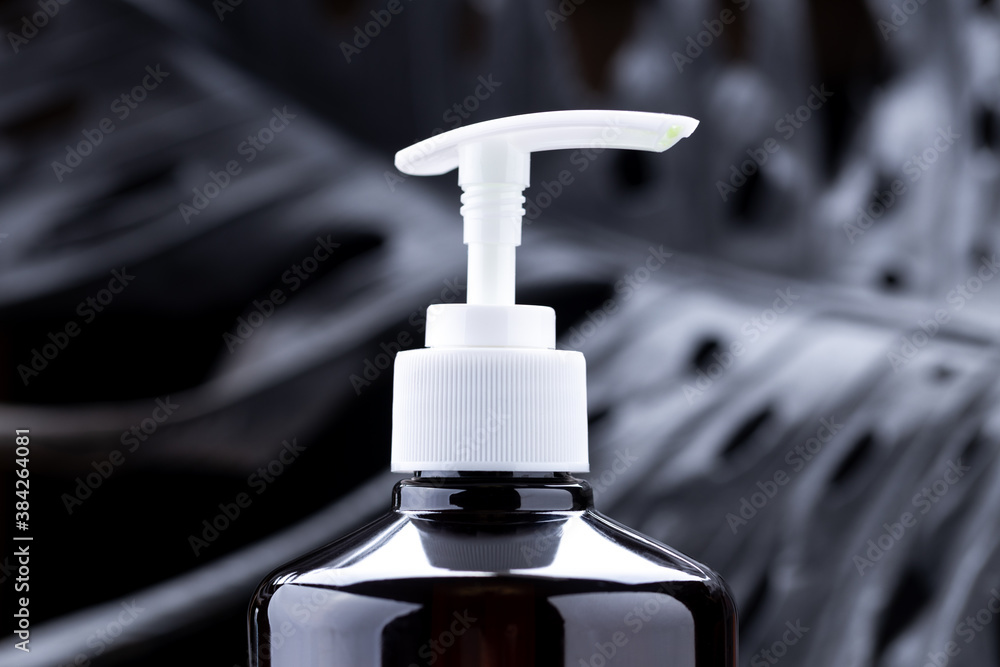 soap dispenser product bottle over dark luxury background. copy space
