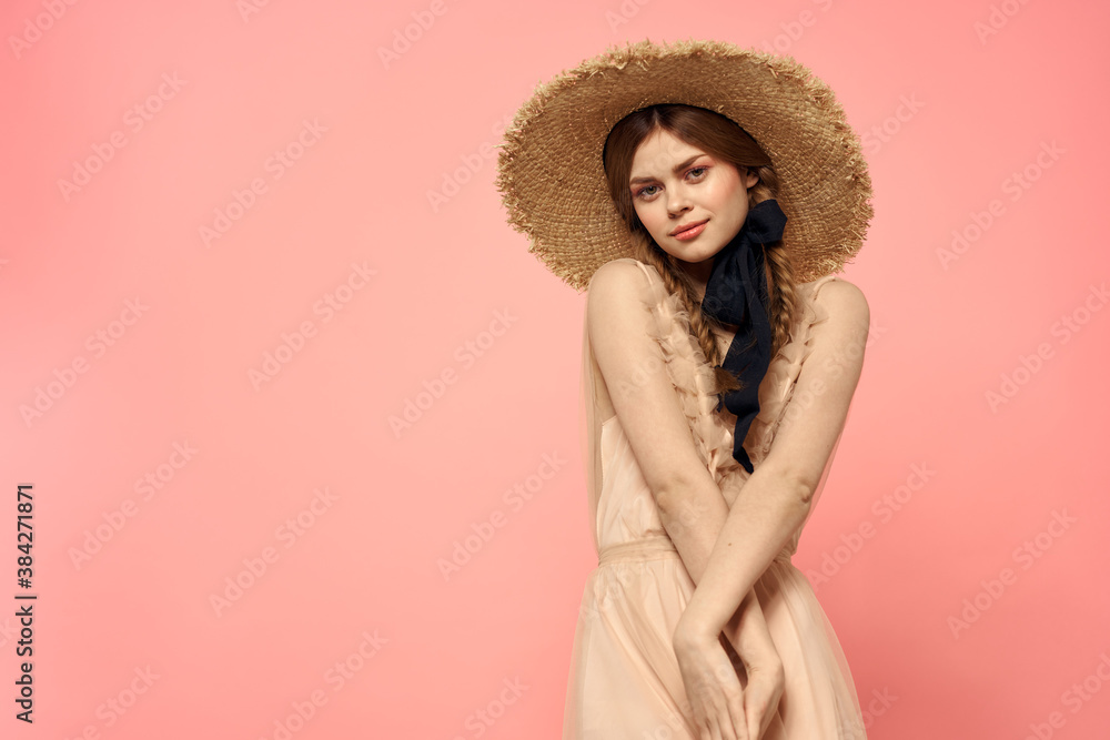 Fashionable woman in dress and hat with black ribbon on pink background cropped view of model emotions fun Fashionable woman in dress and hat with black ribbon on pink background cropped view of model emotions fun
