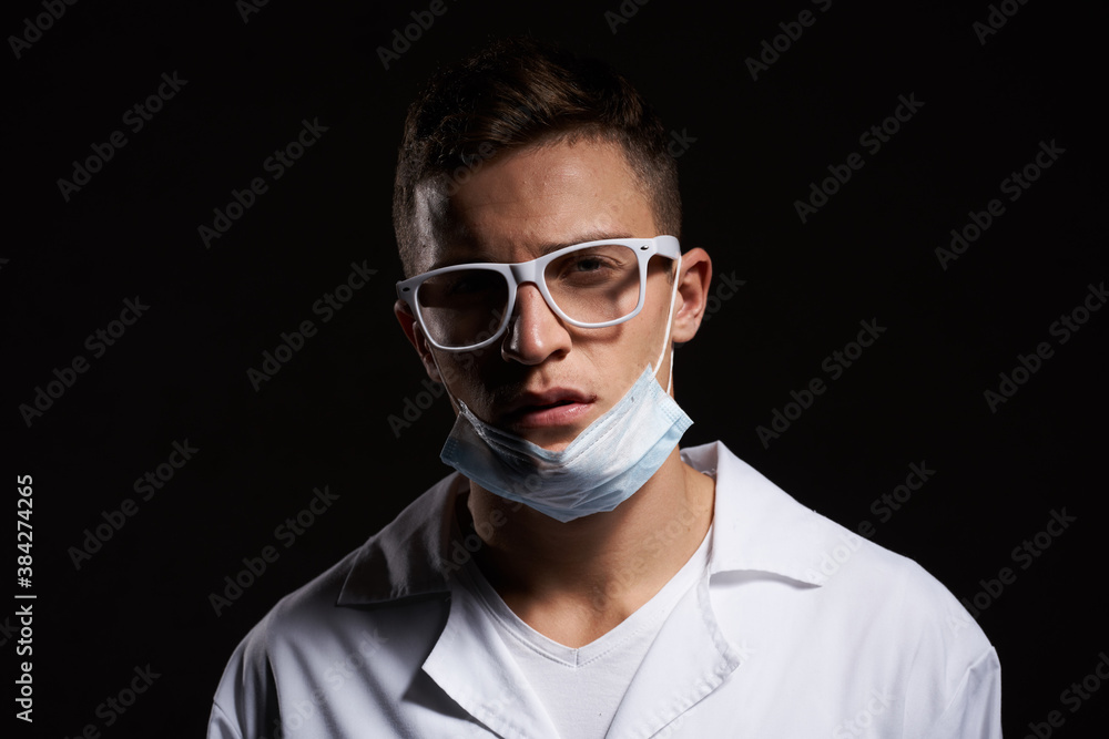 doctor in protective medical mask and glasses on black background close-up portrait cropped view doctor in protective medical mask and glasses on black background close-up portrait cropped view