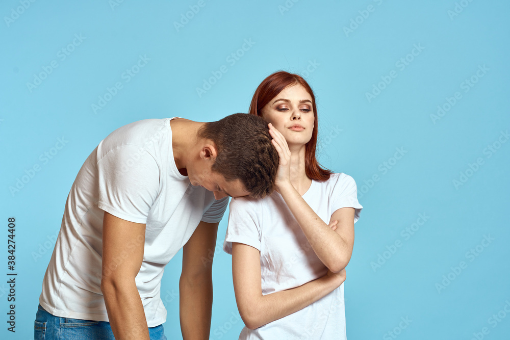 Young woman and man stinks relationship on blue background cropped view of couple in love Young woman and man stinks relationship on blue background cropped view of couple in love