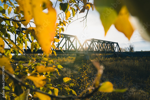 Maintenance Trains Crossing Truss Bridge in Autumn