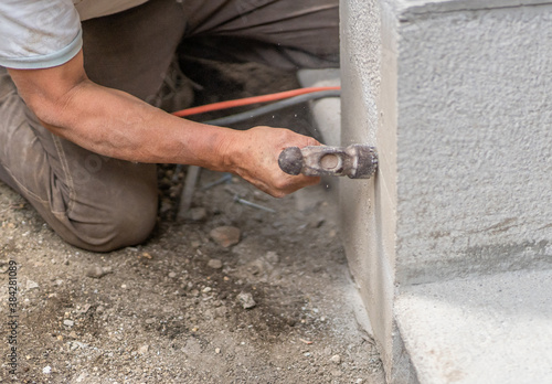 Close up of constuctor man using hammer. Hispanic man working with hammer.