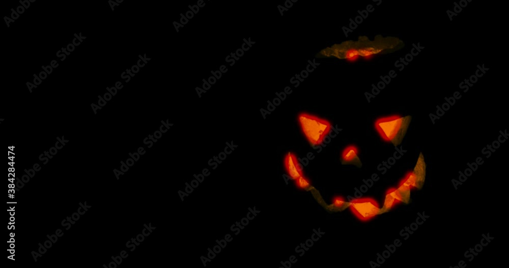 Pumpkin for Halloween glowing demon face in dark. Scary Halloween pumpkin face Pumpkin for Halloween glowing demon face in dark. Scary Halloween pumpkin face