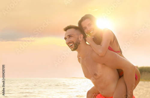 Happy young couple having fun on beach on sunny day © New Africa