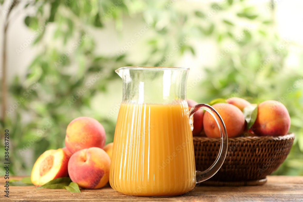Natural peach juice and fresh fruits on wooden table Natural peach juice and fresh fruits on wooden table