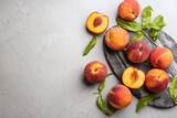 Fresh sweet peaches on light table, flat lay. Space for text