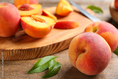 Fresh sweet peaches on wooden table, closeup