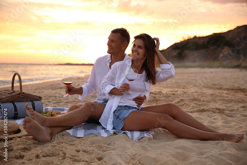 Lovely couple having romantic picnic on beach at sunset © New Africa