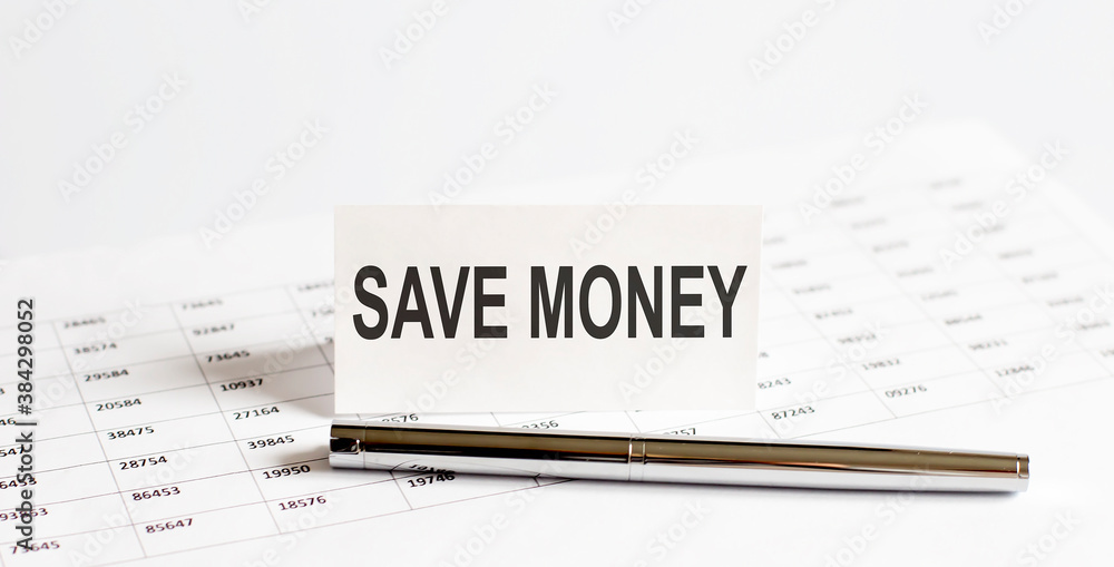 Fototapeta premium Text SAVE MONEY on stickers,pen on the background of documents. Financial bookkeeping, Accounting Concept. Top view.