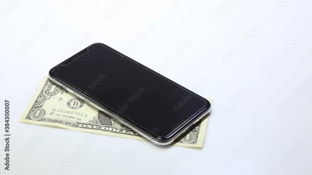 Mobile phones and banknotes on white Mobile phones and banknotes on white