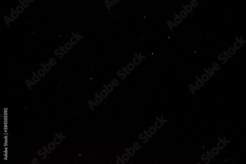 Stars on a dark night sky. Blurred  defocus. Abstract background