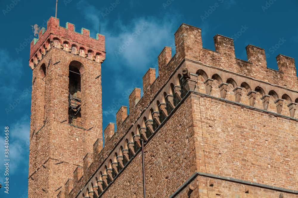 The Palazzo Vecchio (Old Palace) is the town hall of Florence, Italy. Detail of the tower and the wall with battlements and crenellation. The Palazzo Vecchio (Old Palace) is the town hall of Florence, Italy. Detail of the tower and the wall with battlements and crenellation.