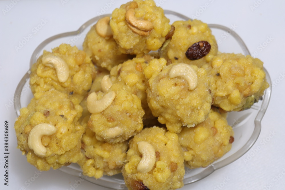 pile of indian sweet bundi laddu or motichur laddu stacked on white background pile of indian sweet bundi laddu or motichur laddu stacked on white background