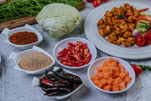 Diced carrots, dried chilies, roasted rice, chili, and cabbage. © Johnstocker