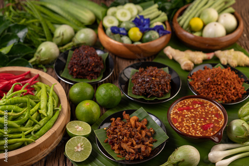 Different types of chili sauce in a cup with ingredients to make