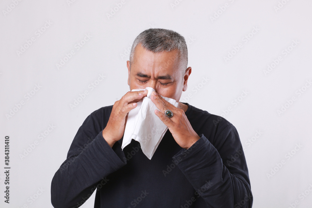 asian old man sick and sneeze with tissue paper isolated on white background asian old man sick and sneeze with tissue paper isolated on white background