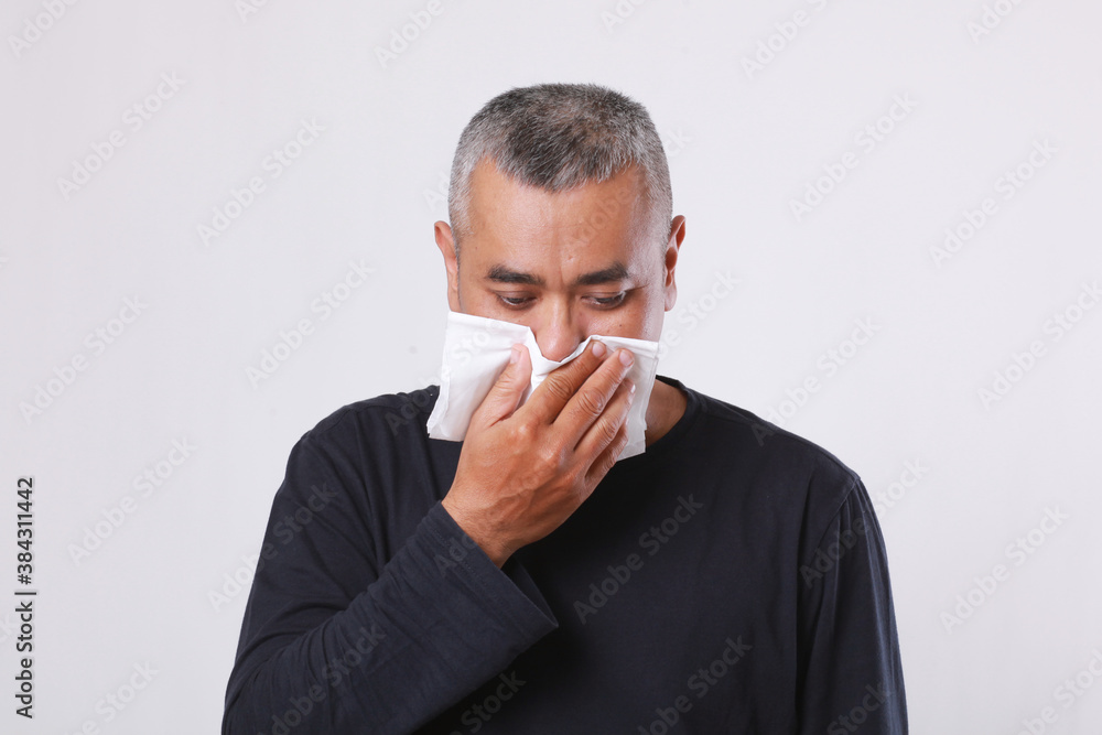 asian old man sick and sneeze with tissue paper isolated on white background asian old man sick and sneeze with tissue paper isolated on white background