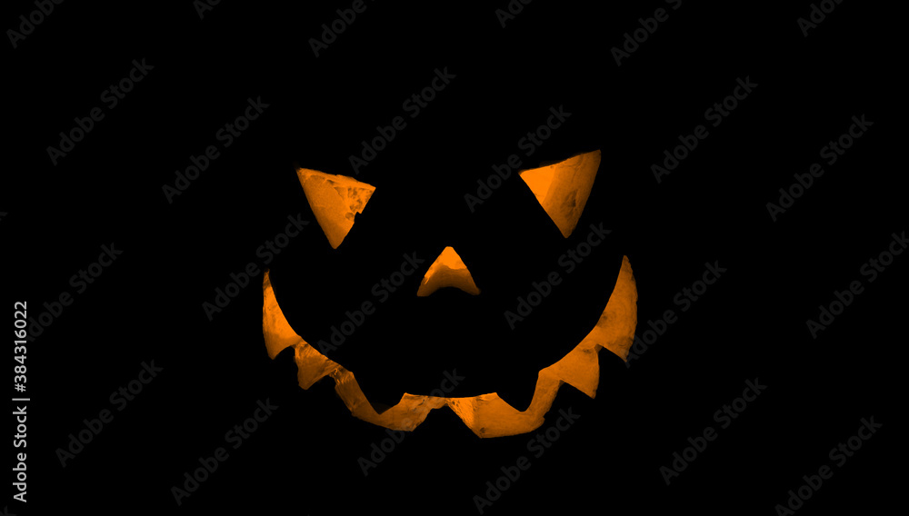 Fototapeta premium Pumpkin for Halloween glowing demon face in dark. Scary Halloween pumpkin face 