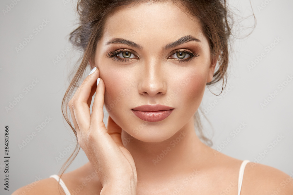 close-up portrait of gorgeous woman with brown and gold mua