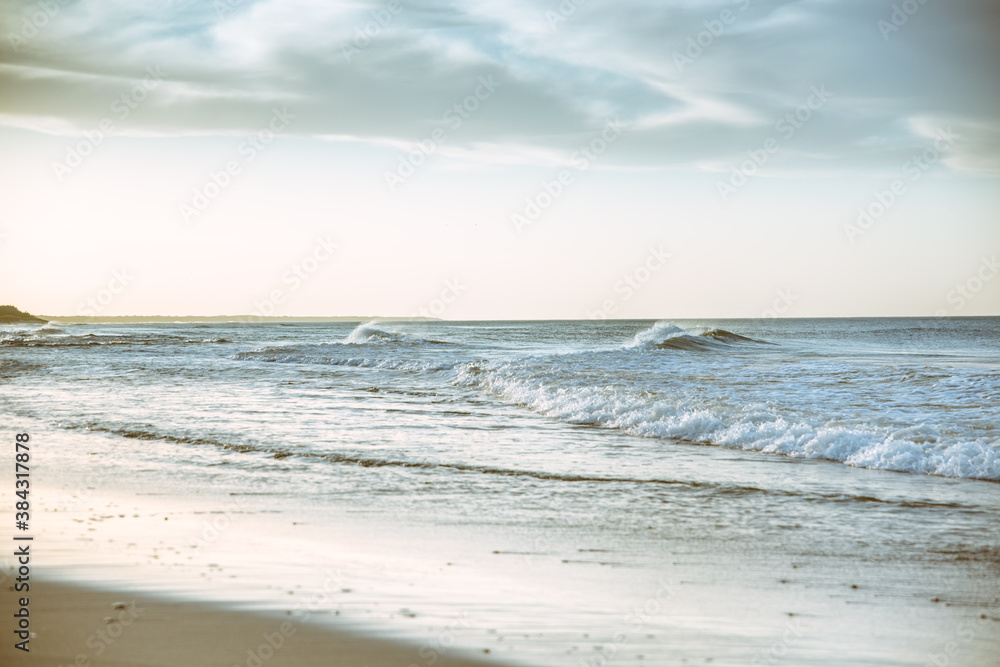 Fototapeta premium Beach photography - blue ocean waves, sand, overcast sky