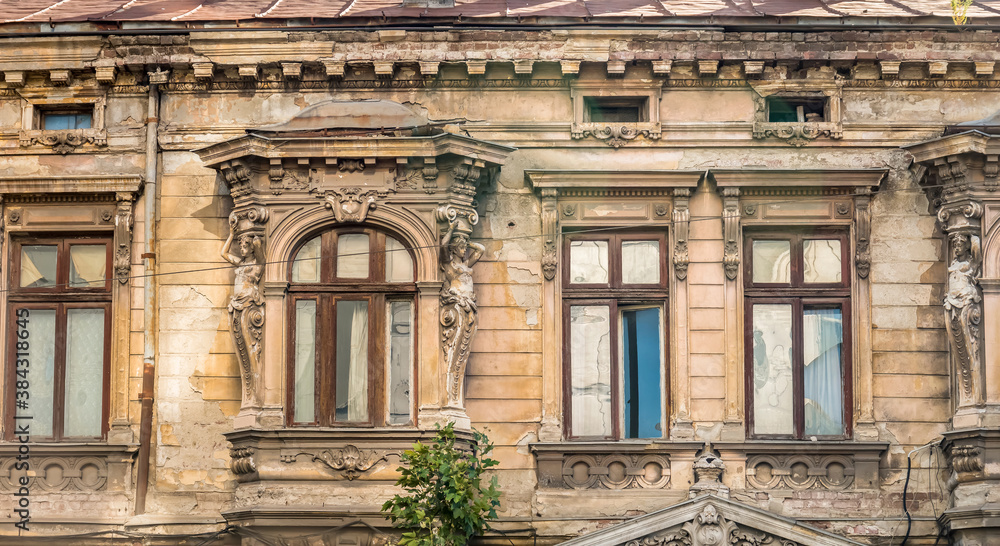 Detail with an old worn out building. Old vintage architecture in Bucharest, Romania.