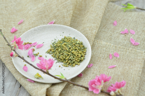 White plate with rice tea and peach flower blooming