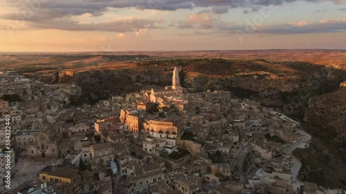sassi di matera old town aerial view drone at sunset,flying orbit over city center at dusk photo