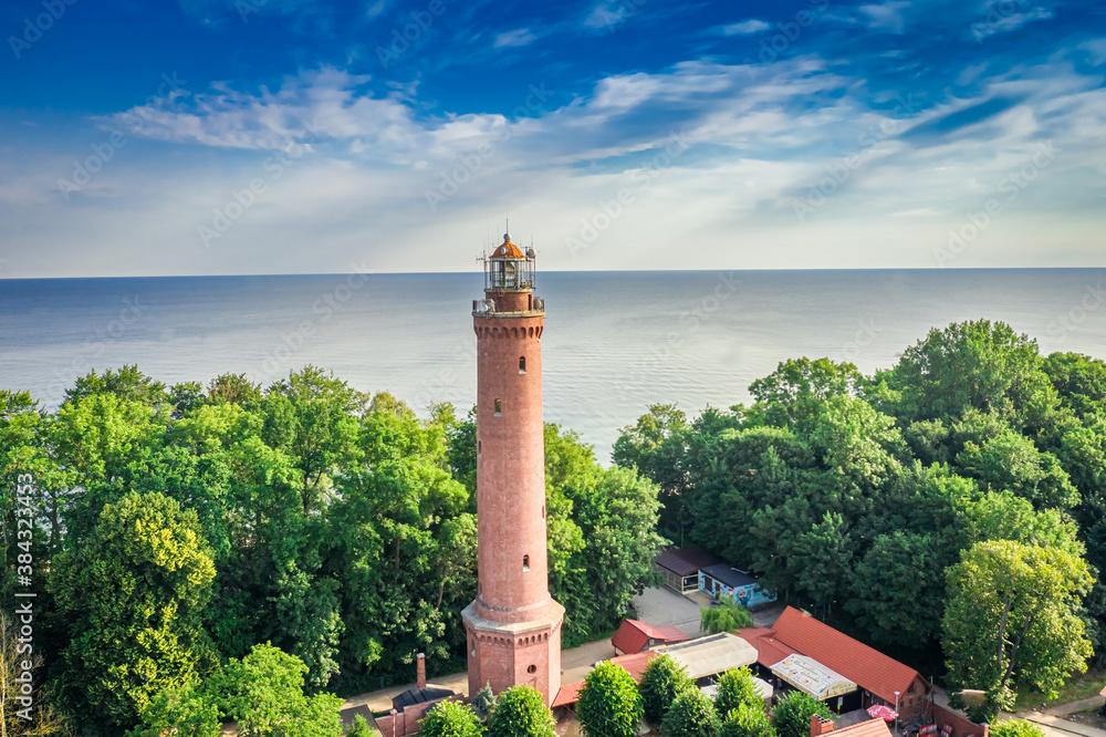 Lighthouse in summer by Baltic Sea, aerial view