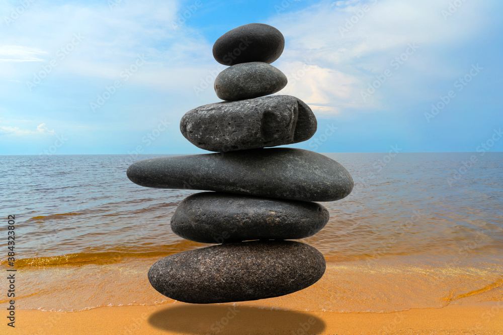 Stack of pebbles in an unstable state. A pyramid made of flat stones. Stack of pebbles in an unstable state. A pyramid made of flat stones.