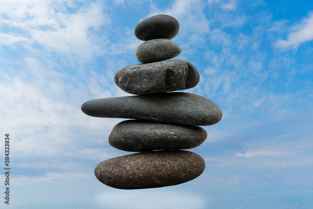 Stack of pebbles in an unstable state. A pyramid made of flat stones. Stack of pebbles in an unstable state. A pyramid made of flat stones.