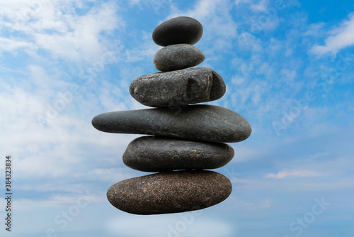 Stack of pebbles in an unstable state. A pyramid made of flat stones.