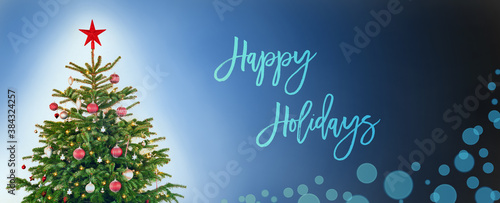 English Text Happy Holidays. Christmas Tree With Christmas Ball Decoration And Ornamen Like Star. Blue Background WIth Bokeh Effect.
